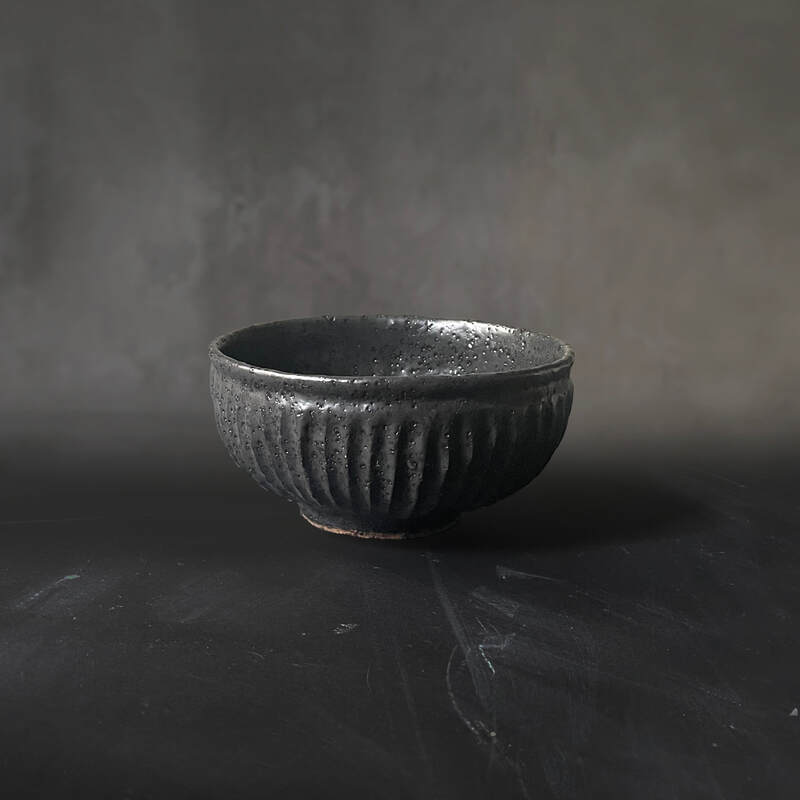 Hand-built and carved BRT bowl with black matt glaze.