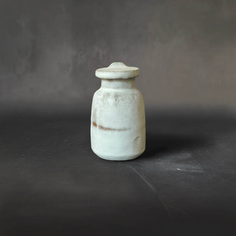 Hand-built red raku pot with lid and white dolomite glaze