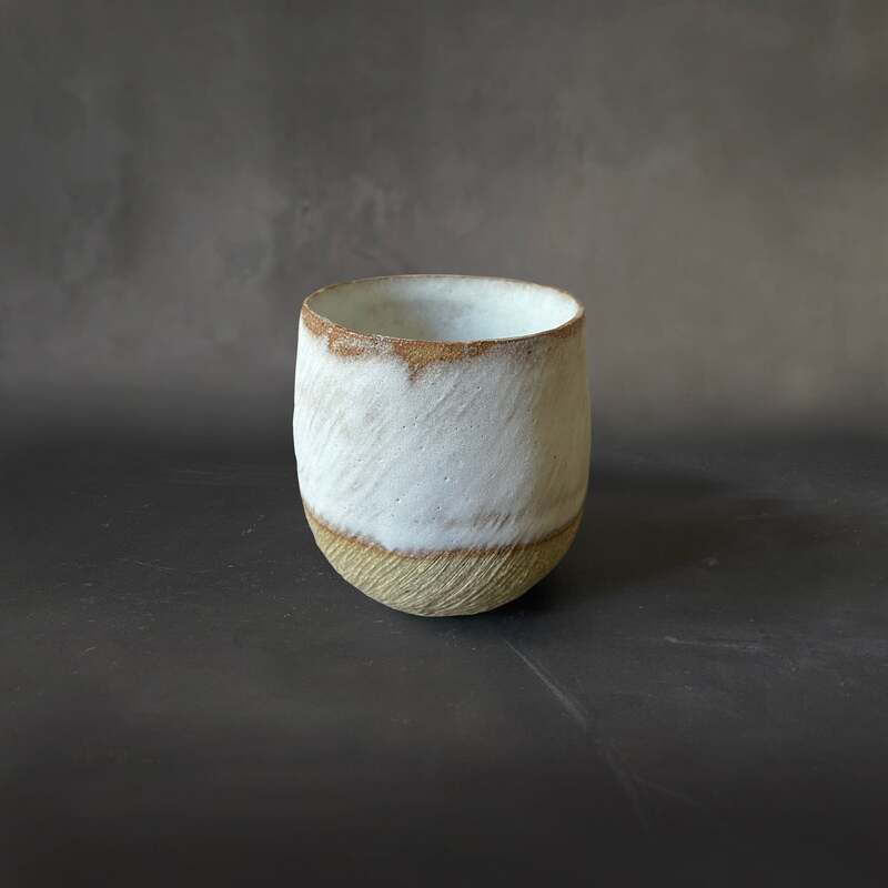 Hand-built, carved toast clay cup with white dolomite glaze