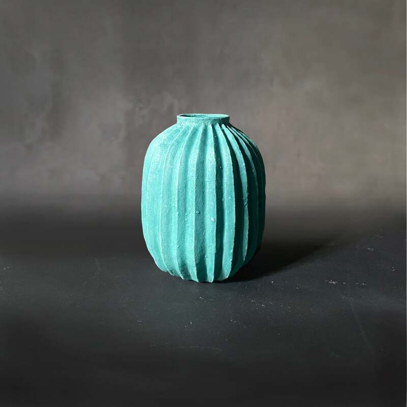 Hand-built and carved teal vase.